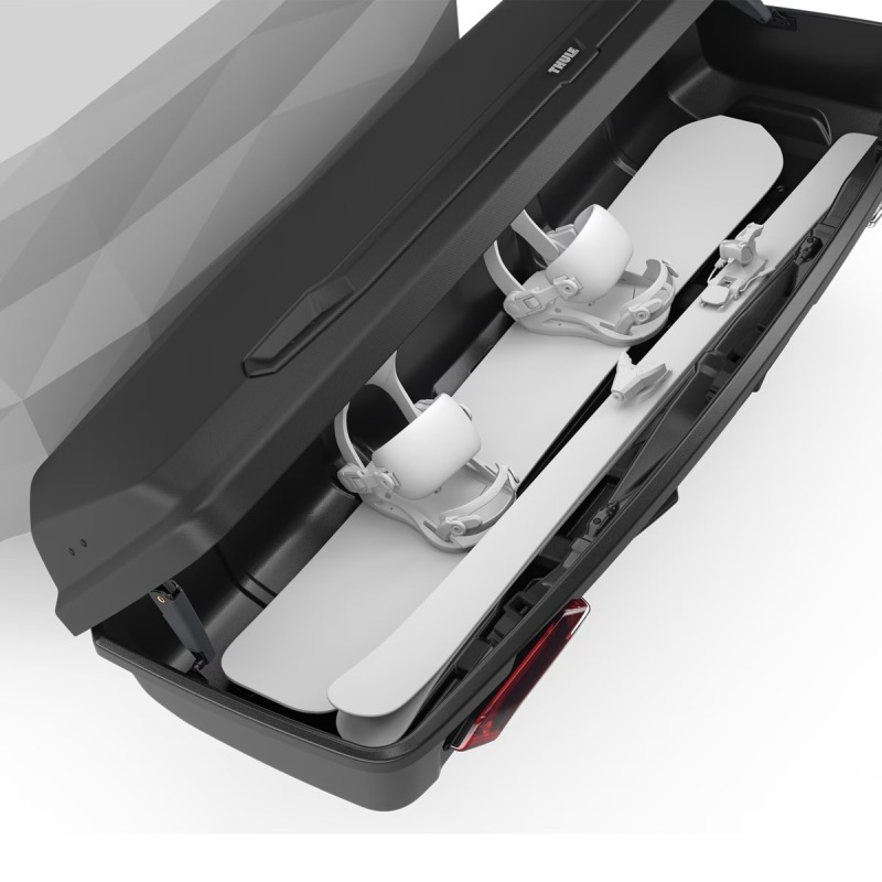 Thule Arcos XL on towbar open with skiis and snowboard inside