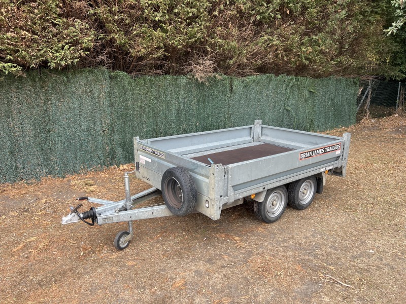 Used 2015 Brian James Cargo Compact 400-0210 flatbed trailer with drop sides and loading ramps