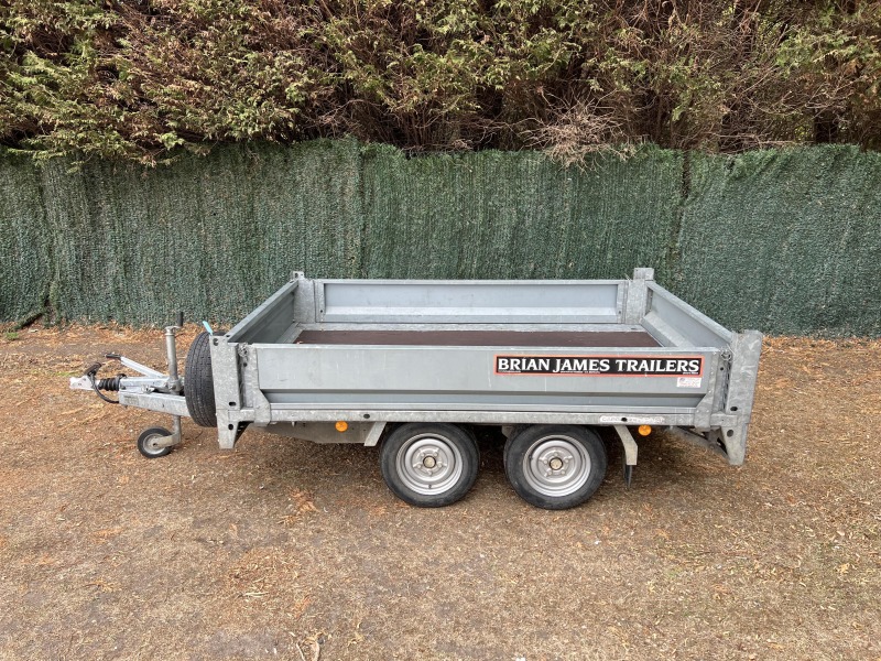 Used 2015 Brian James Cargo Compact 400-0210 flatbed trailer with drop sides and loading ramps