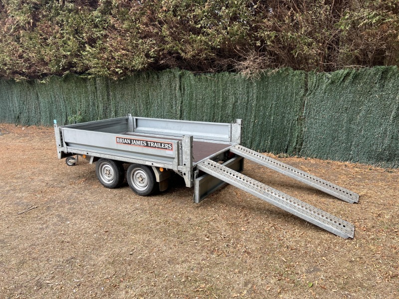 Used 2015 Brian James Cargo Compact 400-0210 flatbed trailer with drop sides and loading ramps