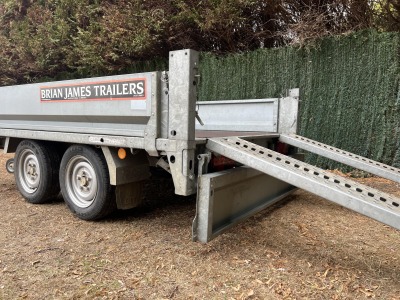 Used 2015 Brian James Cargo Compact 400-0210 flatbed trailer with drop sides and loading ramps