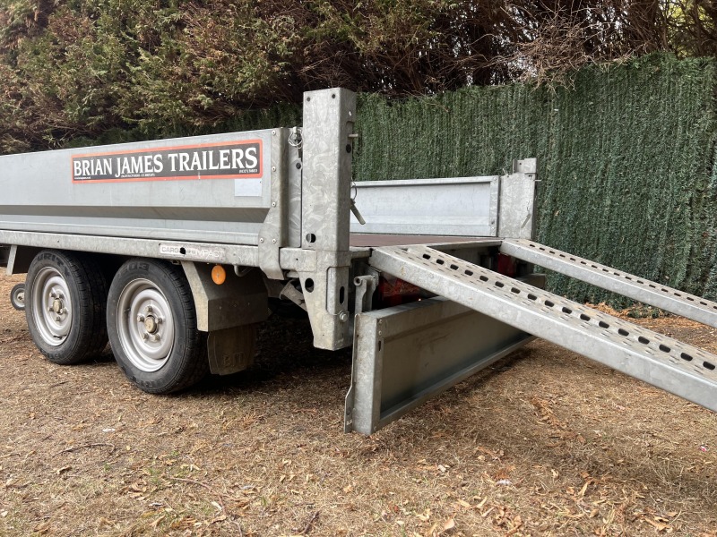 Used 2015 Brian James Cargo Compact 400-0210 flatbed trailer with drop sides and loading ramps